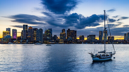 Fototapeta na wymiar Boston skyline at sunset from the East with clouds