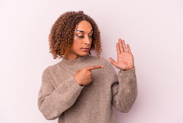 Young latin transsexual woman isolated on pink background smiling cheerful showing number five with...