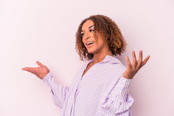 Young latin transsexual woman isolated on pink background joyful laughing a lot. Happiness concept.