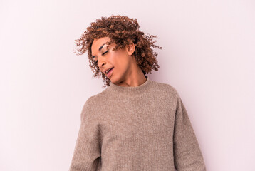 Young latin transsexual woman isolated on pink background dancing and having fun.