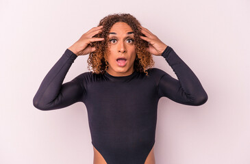 Young latin transsexual woman isolated on pink background receiving a pleasant surprise, excited and raising hands.