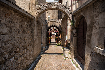 Fototapeta na wymiar Castelvecchio Calvisio medieval town, narrow streets, steps, archs and medieval buidings