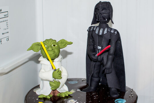 POZNAN, POLAND - Apr 06, 2018: Closeup of Darth Vader and Master Yoda figures on a cake.