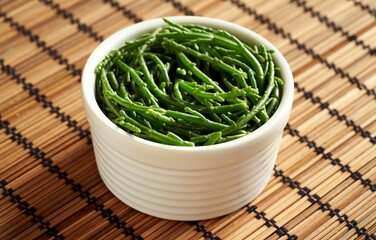 Fresh green seaweed or algae in a bowl on a table