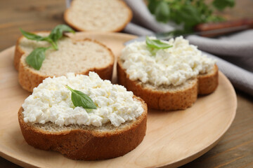 Bread with cottage cheese and basil on wooden table, closeup - Powered by Adobe