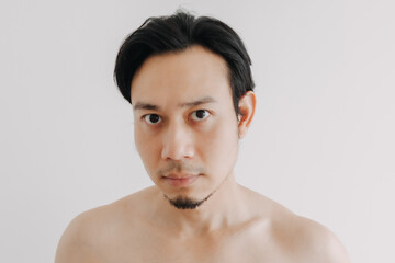 Shirtless Asian man show off his face and skin for skincare product.