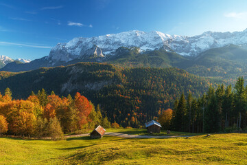 Hiking on top of mountain Eckbauer in autumn with fall colors and snow on the surrounding...