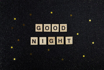 Good night text wooden cubes on black background.Top view, flat lay.
