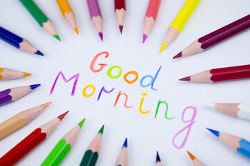 The inscription "Good morning". Colorful pencils. Lettering with colored pencils on white paper