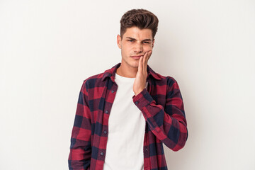 Young caucasian man isolated on white background having a strong teeth pain, molar ache.