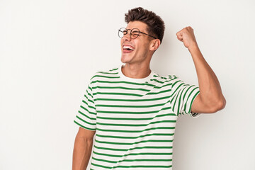 Young caucasian man isolated on white background celebrating a victory, passion and enthusiasm, happy expression.