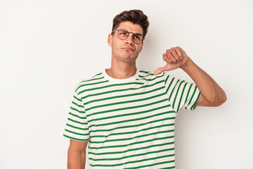 Young caucasian man isolated on white background sad, serious face, feeling miserable and displeased.