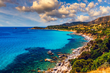 Fototapeta na wymiar The beautiful turquoise water and white sand of Piscadeddus Beach, near Villasimius, Sardinia. The beautiful turquoise water and white sand of Piscadeddus Beach, near Villasimius, Sardinia.