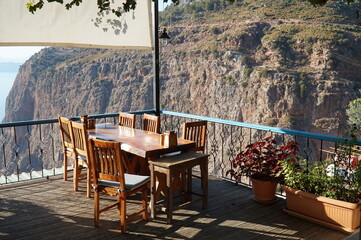 A sun-drenched veranda with tables and chairs in a cafe next to the Valley of the Butterflies in southern Turkey.