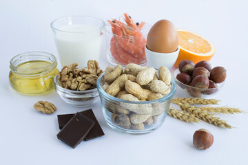 Close-up on food allergens on the white  background. Copy space. Food allergy concept. - obrazy, fototapety, plakaty
