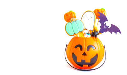 Pumpkin candy bowl and treats for halloween on white background