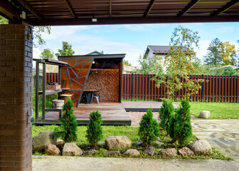 Picnic area with barbecue grill and table and chairs.