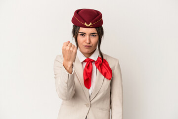 Young caucasian stewardess woman isolated on white background showing fist to camera, aggressive facial expression.