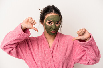 Young caucasian woman wearing a facial mask isolated on white background feels proud and self confident, example to follow.