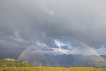 Amazing hiking day in one of the most beautiful area in Switzerland called Pizol in the canton of Saint Gallen. What a wonderful rainbow at the horizon. Beautiful colors. Epic view.