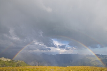 Amazing hiking day in one of the most beautiful area in Switzerland called Pizol in the canton of Saint Gallen. What a wonderful rainbow at the horizon. Beautiful colors. Epic view.