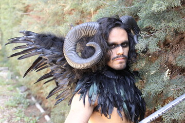 Spooky forest character with horns and wings 