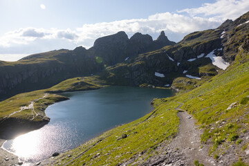 Naklejka premium Amazing hiking day in one of the most beautiful area in Switzerland called Pizol in the canton of Saint Gallen. What a wonderful landscape in Switzerland at a sunny day. Beautiful blue alpine lake.