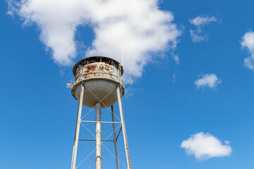 Old, rusty water tower. Concept of clean drinking water, water supply shortage and pollution