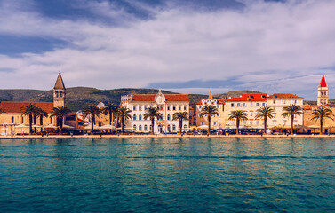 Historic buildings on promenade in Trogir, Croatia. Trogir is popular travel destination in Croatia. Trogir, as a UNESCO World Heritage Site, is one of most visited places in Dalmatia, Croatia.