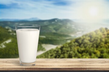 Glass and jug of fresh tasty milk, dairy products
