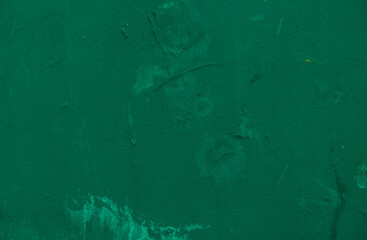 Wall with old cracked green plaster.