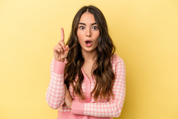 Young caucasian woman isolated on yellow background having some great idea, concept of creativity.