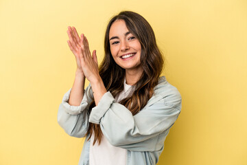 Young caucasian woman isolated on yellow background feeling energetic and comfortable, rubbing hands confident.