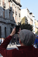 person taking a photo whit a cellphone in the city