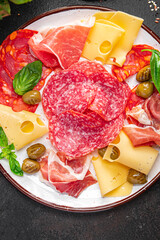 snack plate appetizer meat, sausage, cheese, ham, olives fresh meal on the table copy space food background 