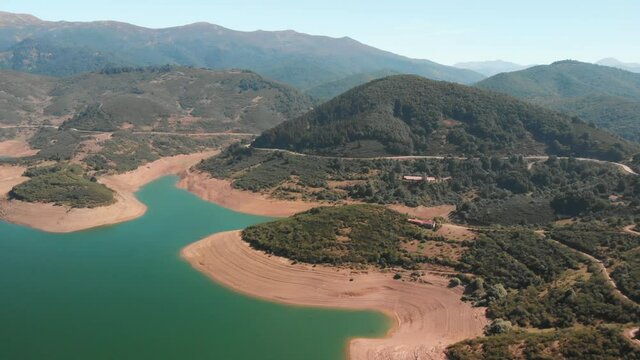 Aerial aerial drone shot of a swamp. The lake shines on a sunny day with the hills outlining its clear waters