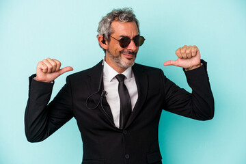 Middle age bodyguard caucasian man isolated on blue background  feels proud and self confident, example to follow.