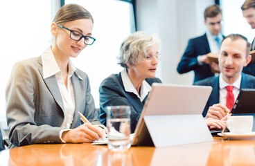 Young business woman working with her colleagues in meeting