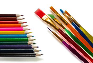 set of colored pencils and brushes for painting on a white background. Stationery close up abstract background