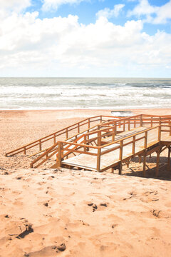 Long wooden bridge overlooking the sea on the beautiful Argentina coast in Ostende. Photo of the beautiful landscape of one of Ostend's beaches.