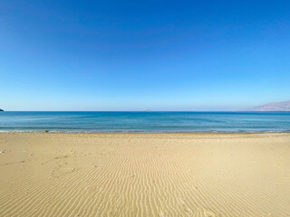 Sea like a mirror at the Komo beach in the south of Crete in Greece. With its golden sand stretches for more than four kilometers on the western edge of the fertile Messara plain