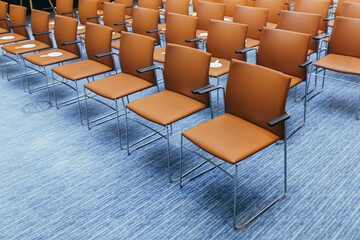 large empty conference room with orange chairs before the auction
