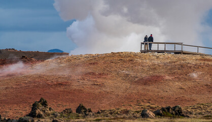 Rear view of unrecognizable people looking at the fumarole