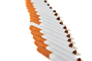 Cigarettes lies with a filter to us on a white background. One cigarette is different from the others