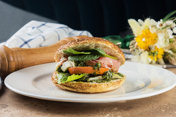 Bagel with salmon, cucumber and basil.