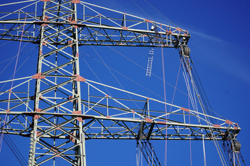 Electric power pylons for high-voltage lines under construction to bring electrical energy...