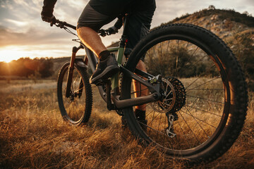 Crop bicyclist riding bike offroad