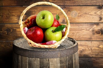 Fresh ripe sweet apples in the basket on the desk
