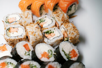Sushi set with salmon, tuna and cream cheese close-up. Traditional Japanese cuisine.