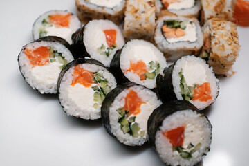 Sushi roll set with salmon, tuna and cream cheese close-up. Traditional Japanese cuisine.